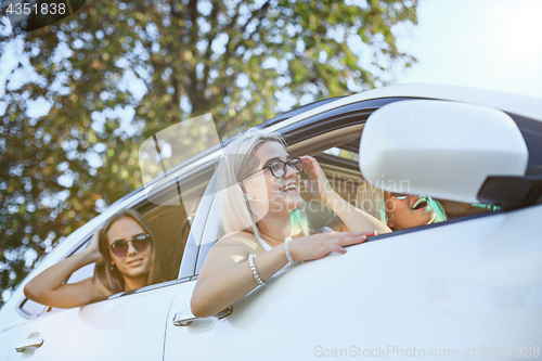 Image of The young women in the car smiling