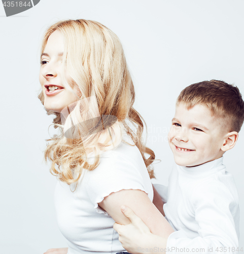 Image of young modern blond curly mother with cute son together happy smiling family posing cheerful on white background, lifestyle people concept, sister and brother friends 