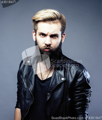 Image of portrait of young bearded hipster guy on gray dark background close up, brutal modern man, lifestyle people concept 