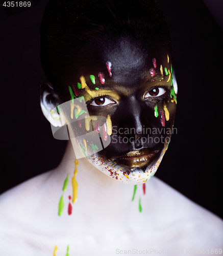 Image of woman with creative makeup closeup like drops of colors, facepai