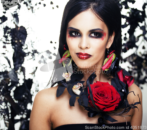 Image of pretty brunette woman with rose jewelry, black and red, bright m