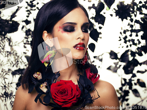 Image of pretty brunette woman with rose jewelry, black and red, bright m