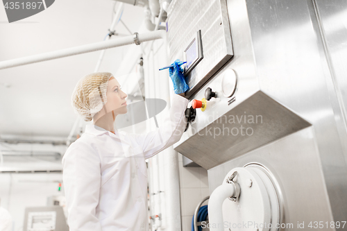 Image of woman programming computer at ice cream factory