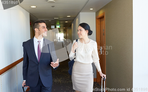 Image of business team with travel bags at hotel corridor