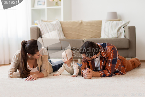 Image of happy family playing with baby at home