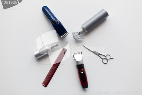 Image of styling hair sprays, clippers, comb and scissors