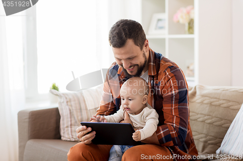 Image of happy father and baby boy with tablet pc at home