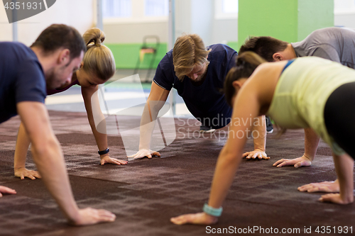 Image of group of people exercising in gym