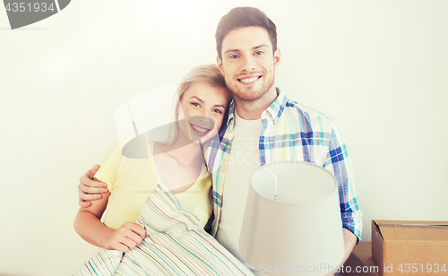 Image of happy couple with stuff moving to new home