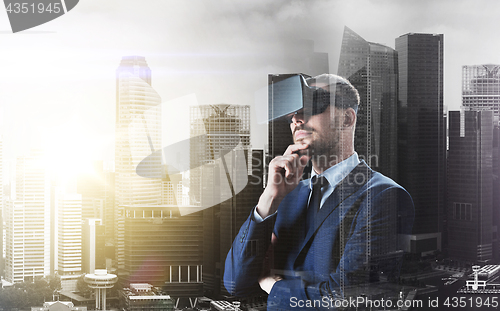 Image of businessman in virtual reality headset over city