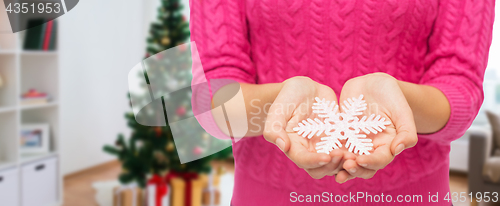 Image of close up of woman hands with christmas snowflake