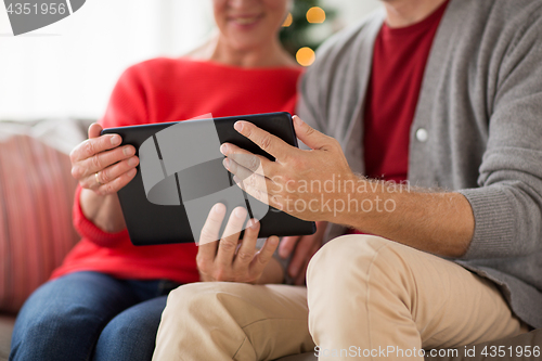 Image of senior couple with tablet pc at christmas