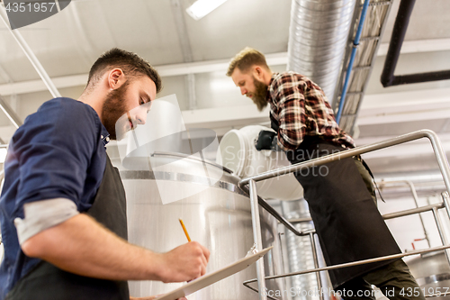 Image of men working at craft brewery or beer plant