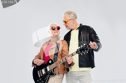 Image of senior couple in sunglasses with electric guitar