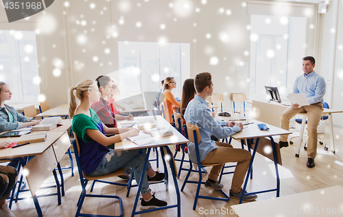 Image of group of students and teacher with papers or tests