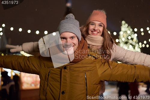 Image of happy couple having fun at christmas market