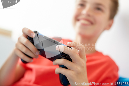 Image of close up of boy with gamepad playing video game