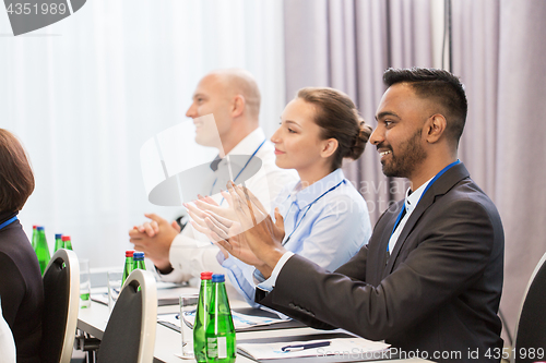 Image of people applauding at business conference