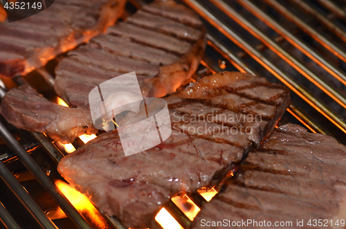 Image of Beef steaks on the grill