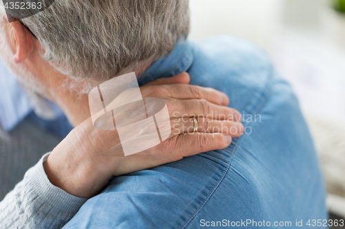 Image of close up of married senior couple hugging