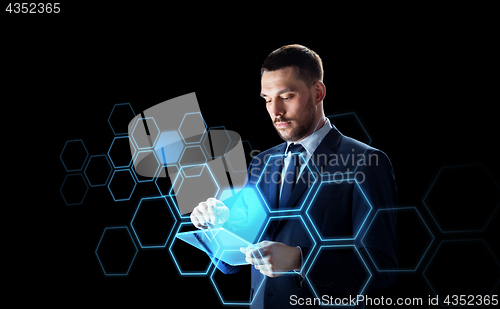 Image of businessman with tablet pc and network hologram