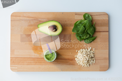 Image of jar with puree or baby food on wooden board