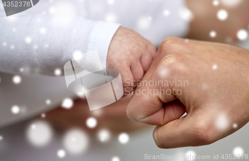 Image of close up of mother and newborn baby hands