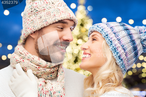 Image of close up of happy couple over christmas lights