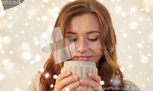 Image of close up of woman with tea or coffee cup at home