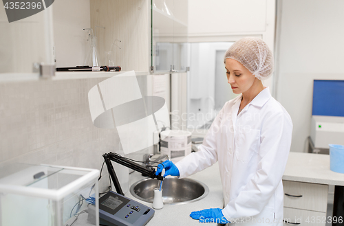 Image of scientist with flask making test at laboratory