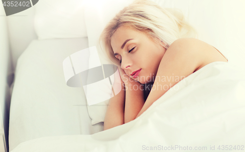 Image of young woman sleeping in bed at home bedroom