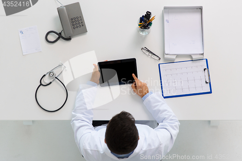 Image of doctor with tablet pc and cardiogram at clinic