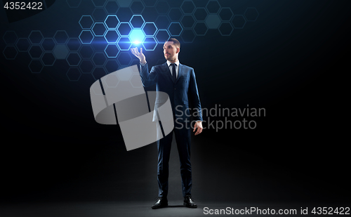 Image of businessman working with virtual network hologram
