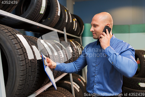 Image of auto business owner ordering tires at car service