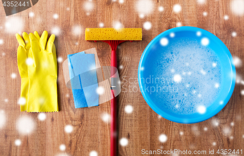 Image of squeegee with window cleaning stuff on wood