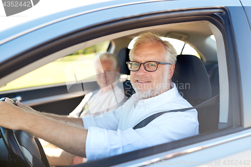 Image of happy senior couple driving in car