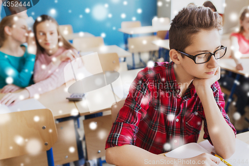 Image of students gossiping behind classmate back at school