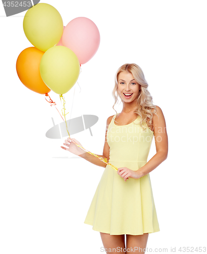 Image of happy woman in dress with helium air balloons