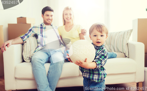 Image of happy little boy with ball over parents at home