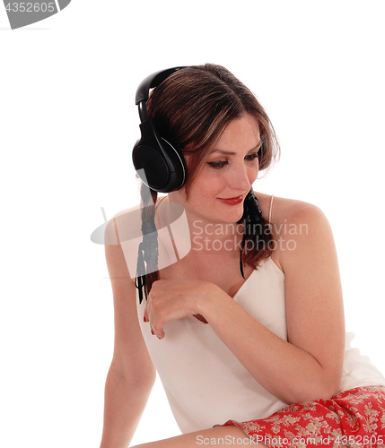 Image of Woman sitting on floor with headset.