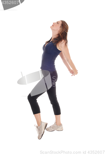 Image of Slim woman in profile, stretching.