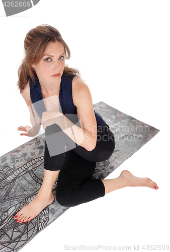 Image of Woman sitting on floor and looking up.