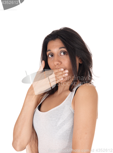 Image of Woman holding hand over mouth looking surprised. 