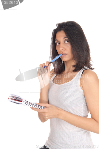 Image of Woman standing with pen in her mouth.