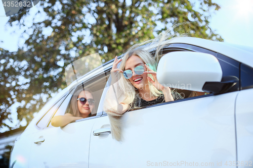 Image of The young women in the car smiling