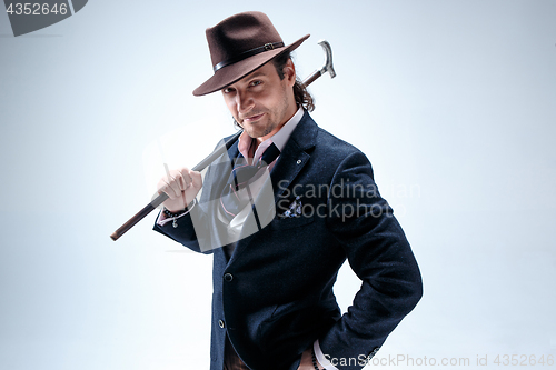 Image of Young man portrait with hat on gray studio background.