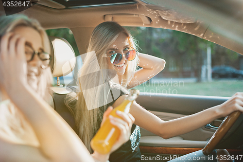 Image of The young women in the car smiling