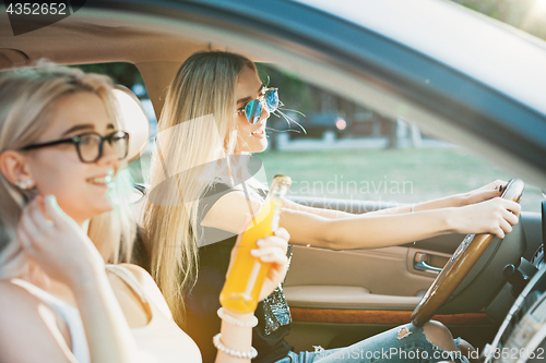 Image of The young women in the car smiling