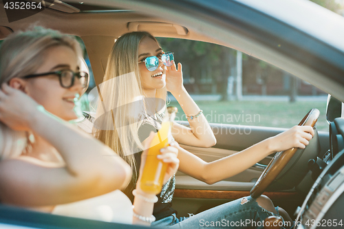 Image of The young women in the car smiling