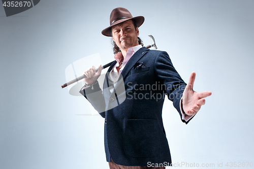 Image of Young man portrait with hat on gray studio background.